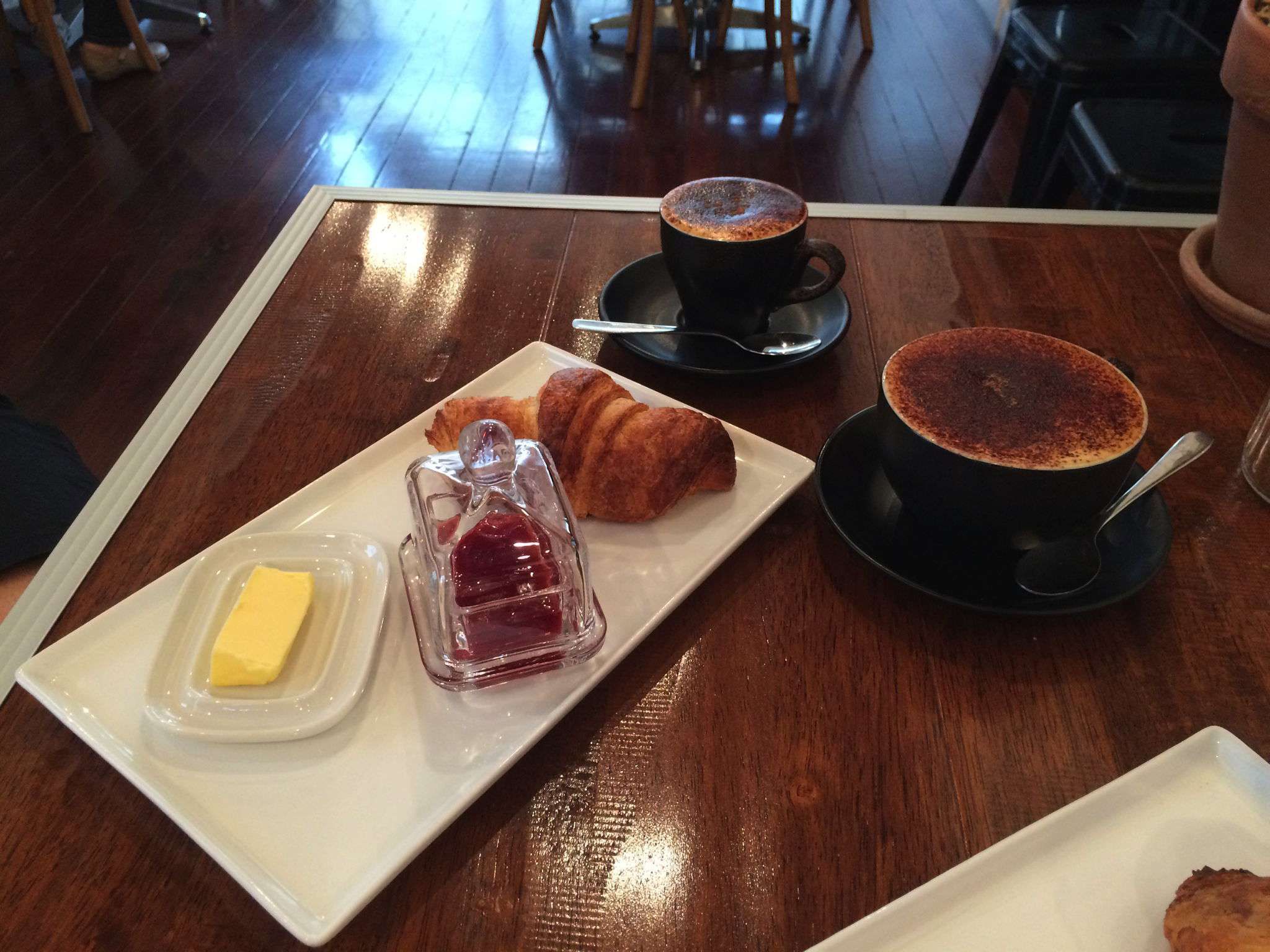 Coffee, crosissant, butter and strawberry jam - a little slice of heaven